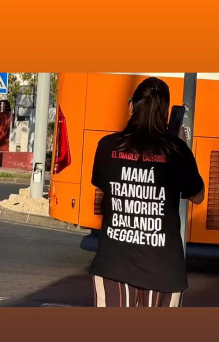 Customer wearing an El Diablo Canario tee at a daytime street party in Tenerife